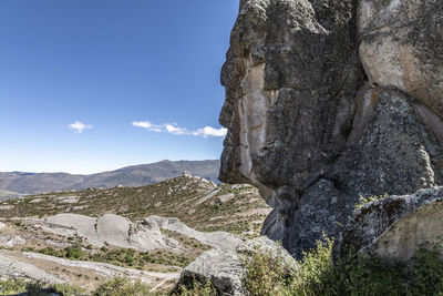 Rock formations on landscape against sky