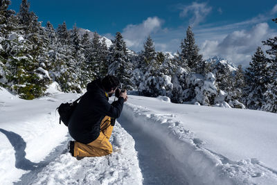 Rear view of person on snow covered landscape