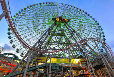 Low angle view of ferris wheel against sky