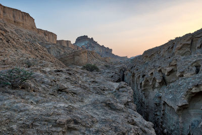 Low angle view of rock formations against sky
