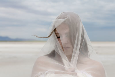 Portrait of woman against sky