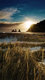 Scenic view of land against sky during sunset