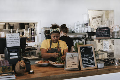 Men standing at restaurant table in cafe