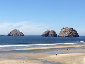 Scenic view of beach against clear sky