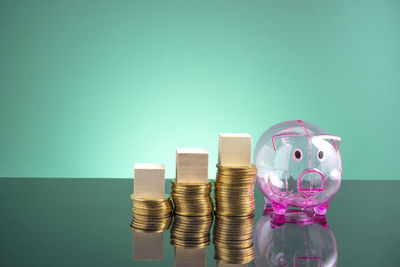 Close-up of coins on table against blue background