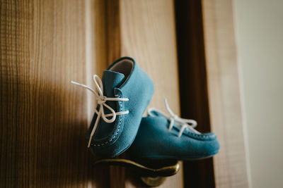 Close-up of shoes on wooden floor