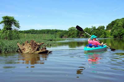 Woman kayaking at scenic lake of olathe, kansas