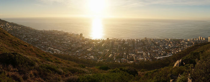 High angle view of townscape by sea against sky