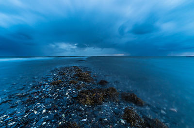 View of calm sea against cloudy sky