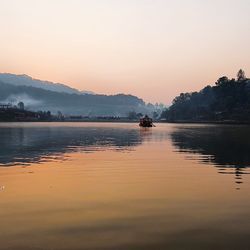 Scenic view of lake against sky during sunset