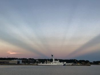 Scenic view of sea and buildings against sky during sunset