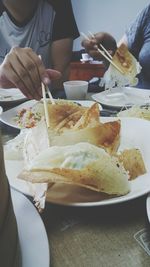 Close-up of hand holding ice cream in plate