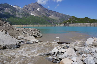 Scenic view of sea and mountains against sky