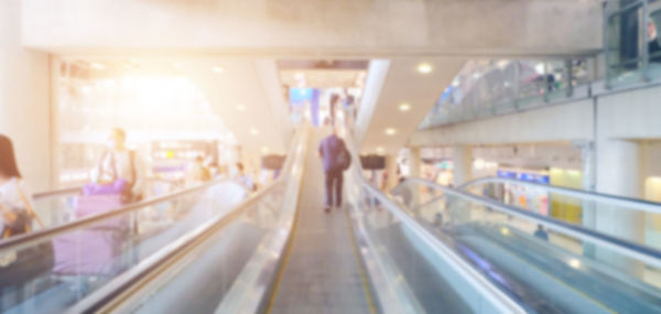 Blurred motion of people standing on illuminated railroad station