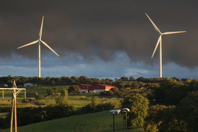 Windmill on field against sky