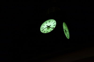 Close-up of clock in darkroom