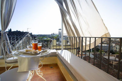 View of glass of building with balcony against sky