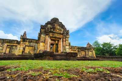 Old temple building against cloudy sky