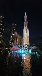 Illuminated modern buildings in city at night