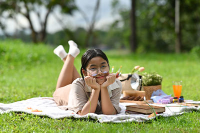 Young woman lying on field