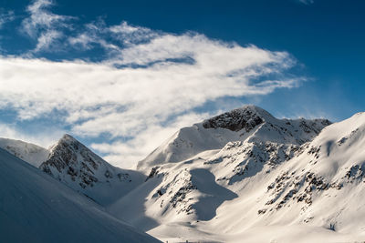 Scenic view of snow covered mountains against sky