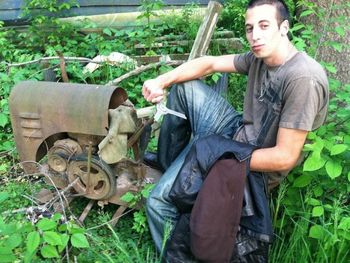 Young man working in car