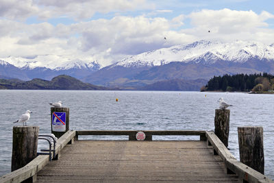 Scenic view of lake by mountains against sky