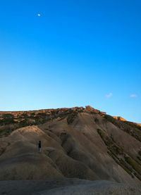 Scenic view of desert against clear blue sky