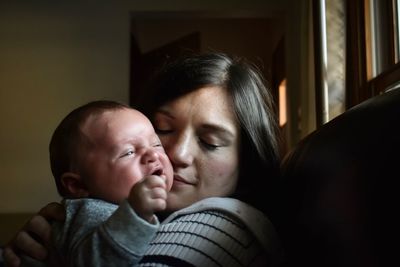 Close-up of mother and baby at home