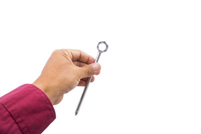 Close-up of hand holding cigarette over white background