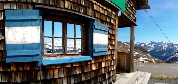 Built structure on snow covered mountains against sky