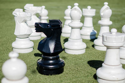 Close-up of chess pieces on sunny day