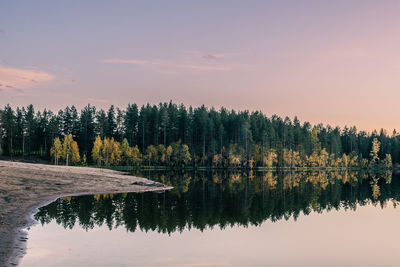 Scenic view of lake against sky at sunset