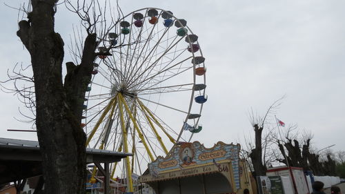 Low angle view of ferris wheel against sky