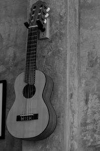 Close-up of guitar against wall