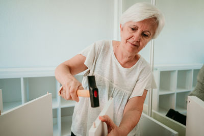 Woman working on wood at home