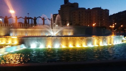 Illuminated fountain at night