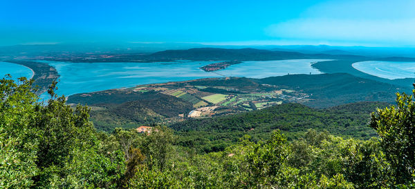 High angle view of sea and trees against sky