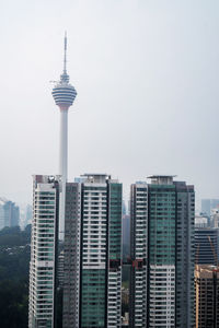 View of buildings in city against clear sky