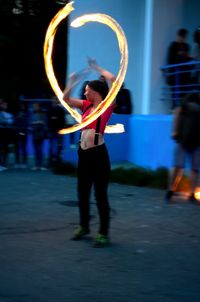 Full length of man standing on illuminated stage at night