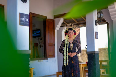 Woman standing in front of building