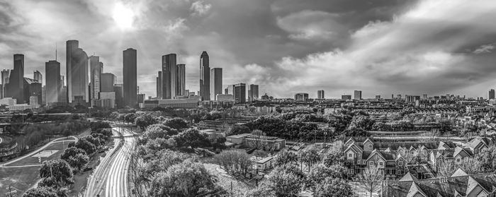 Cityscape against cloudy sky