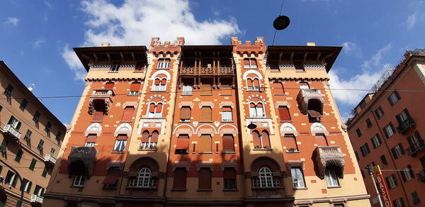 Low angle view of buildings in town against sky