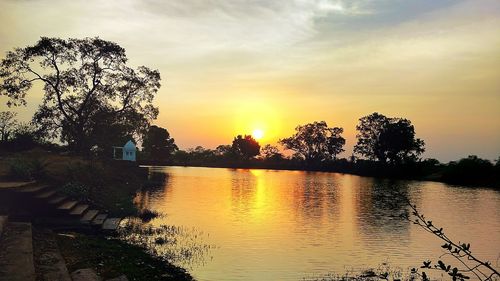 Scenic view of calm lake at sunset