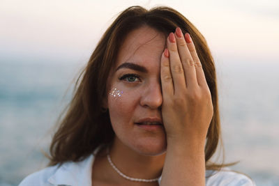 Portrait of a happy young woman on a background of beautiful sea.