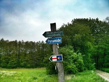 Low angle view of road sign against sky