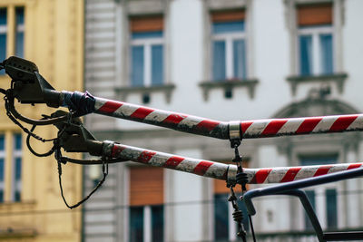 Low angle view of metallic equipment against building in city