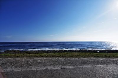 Scenic view of sea against clear blue sky