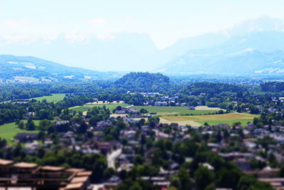 Scenic view of landscape and houses against sky