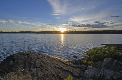 Scenic view of lake against sky during sunset